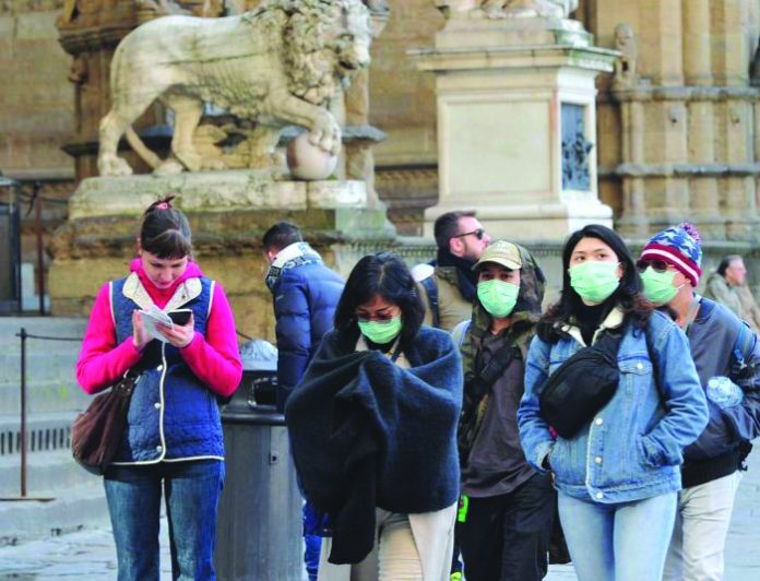Italy locks down People wearing protective masks walk through Florence as Italy battles a coronavirus outbreak, in Florence, Italy, March 7, 2020. People wearing protective masks walk through Florence as Italy battles a coronavirus outbreak, in Florence, Italy, March 7, 2020. REUTERS