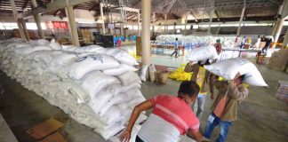 At the Jaro district gymnasium, personnel of the Iloilo City Government prepare these sacks of rice donated by the private sector for repacking and distribution to residents economically displaced by the enhanced community quarantine being observed to stop the spread of the coronavirus disease 2019. IAN PAUL CORDERO/PN