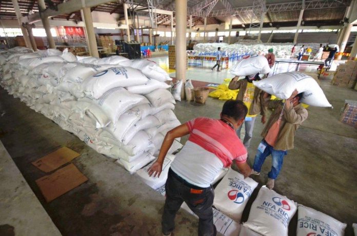 Jaro district gymnasium Food Packs At the Jaro district gymnasium, personnel of the Iloilo City Government prepare these sacks of rice donated by the private sector for repacking and distribution to residents economically displaced by the enhanced community quarantine being observed to stop the spread of the coronavirus disease 2019. IAN PAUL CORDERO/PN