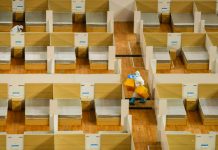 A staff member removes waste after the final patients were discharged from a temporary hospital set up to treat people with the COVID-19 coronavirus in a sports stadium in Wuhan, China. AFP
