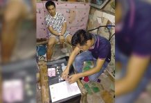 P56-T ‘shabu’ seized An antidrug officer inspects items seized from Mark Lawrence Onggada, who was nabbed in a buy-bust operation in Barangay 3, Bacolod City on March 19. POLICE STATION 2/ BCPO