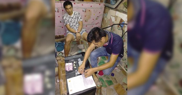 Mark Lawrence Onggada An antidrug officer inspects items seized from Mark Lawrence Onggada, who was nabbed in a buy-bust operation in Barangay 3, Bacolod City on March 19. POLICE STATION 2/ BCPO