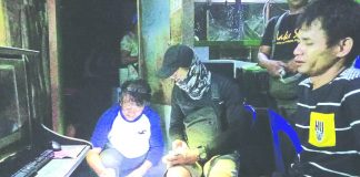 Antidrug officers inspect items seized from Michael Mercado. He was nabbed in an entrapment operation in Barangay 2, Bacolod City on March 1. POLICE STATION 2/BCPO