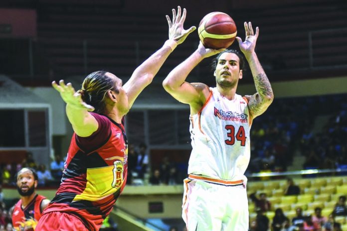 NorthPort Batang Pier’s Christian Standhardinger (No.34) attempts a jumper over San Miguel Beermen star June Mar Fajardo during their match in the Philippine Basketball Association. ABS-CBN SPORTS