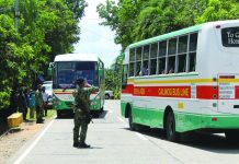 Police officers man a checkpoint on the border between Tapaz, Capiz and Calinog, Iloilo on March 18 as part of precautionary measures to curb the spread of the dreaded coronavirus disease 2019. PDRRMO CAPIZ