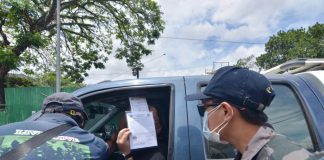 QUARANTINE CHECK. Police officers check a motorist’s credentials at a quarantine control point in Barangay Ungka, Jaro, Iloilo City. The metro is under an enhanced community quarantine to contain the spread of the coronavirus disease 2019. IAN PAUL CORDERO/PN