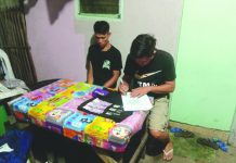 Antidrug officers inspect items seized from resident Ronrick Banaban, who was nabbed in an entrapment operation in Barangay Banago, Bacolod City on March 9. POLICE STATION 8/BCPO