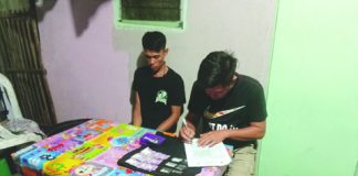 Antidrug officers inspect items seized from resident Ronrick Banaban, who was nabbed in an entrapment operation in Barangay Banago, Bacolod City on March 9. POLICE STATION 8/BCPO