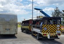 Silay City government provides trucks and a bus to the 84 Negrense persons under monitoring who arrived in Bacolod-Silay Airport in Negros Occidental from Clark International Airport going to a resort on Thursday. They will stay there for a 14-day mandatory quarantine for individuals with possible coronavirus disease 2019 infection. RYAN GAMBOA FACEBOOK PAGE