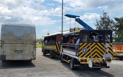 Silay City government provides trucks and a bus to the 84 Negrense persons under monitoring Silay City government provides trucks and a bus to the 84 Negrense persons under monitoring who arrived in Bacolod-Silay Airport in Negros Occidental from Clark International Airport going to a resort on Thursday. They will stay there for a 14-day mandatory quarantine for individuals with possible coronavirus disease 2019 infection. RYAN GAMBOA FACEBOOK PAGE
