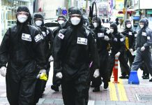 More virus restrictions around the world placed South Korean army soldiers wearing protective suits move to spray disinfectant in Daegu, South Korea, Sunday, March 15, 2020. For most people, the new coronavirus causes only mild or moderate symptoms, such as fever and cough. For some, especially older adults and people with existing health problems, it can cause more severe illness, including pneumonia. KIM HYUN-TAE/YONHAP VIA AP