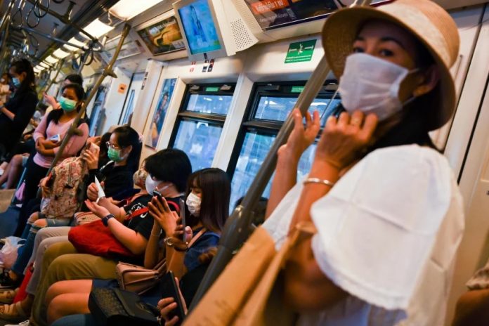 Thailand COVID 2019 Suburan train passengers wear protective face masks amid fears of the spread of the COVID-19 novel coronavirus in Bangkok on February 29, 2020. AFP