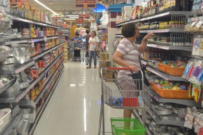 price freeze grocery store in Iloilo City Proclamation 922 which puts the country under a state of public health emergency due to the novel coronavirus outbreak has triggered the implementation of a nationwide price freeze. Photo shows a woman checking prices at a grocery store in Iloilo City. IAN PAUL CORDERO/PN
