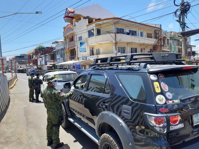 Personnel of the Kalibo municipal police station Personnel of the Kalibo municipal police station strictly implement the enhanced community quarantine and check issued quarantine passes of motorists and passengers who enter the border control point in Barangay Poblacion, Kalibo, Aklan on March 28. PNP KALIBO