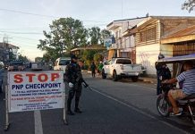 Personnel of the Kalibo municipal police station conduct checkpoint on the National Highway in Barangay Estancia, Kalibo, Aklan on March 19. They also reminded the motorists to observe social distancing as one of the measures against the coronavirus disease 2019 outbreak. KALIBO PNP