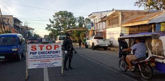 Personnel of the Kalibo municipal police station conduct checkpoint on the National Highway in Barangay Estancia, Kalibo, Aklan on March 19. They also reminded the motorists to observe social distancing as one of the measures against the coronavirus disease 2019 outbreak. KALIBO PNP