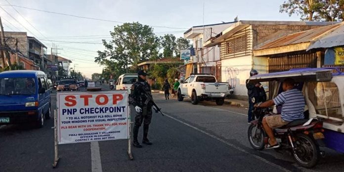 Personnel of the Kalibo municipal police station conduct checkpoint on the National Highway in Barangay Estancia, Kalibo, Aklan on March 19. They also reminded the motorists to observe social distancing as one of the measures against the coronavirus disease 2019 outbreak. KALIBO PNP