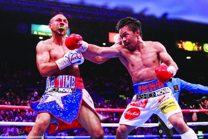 Eight-division world boxing champion Manny “Pacman” Pacquiao trades punches with Keith “One Time” Thurman during their title bout last year. Pacquiao said that he tested negative for the coronavirus disease 2019 yesterday. ABS-CBN SPORTS