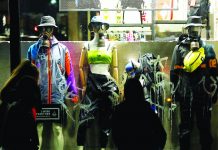 Mannequins wearing protective masks stand in a shop display window in Rome, Italy on March 6. REUTERS/ REMO CASILLI