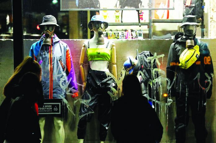 Mannequins wearing protective masks stand in a shop display window in Rome, Italy on March 6. REUTERS/ REMO CASILLI