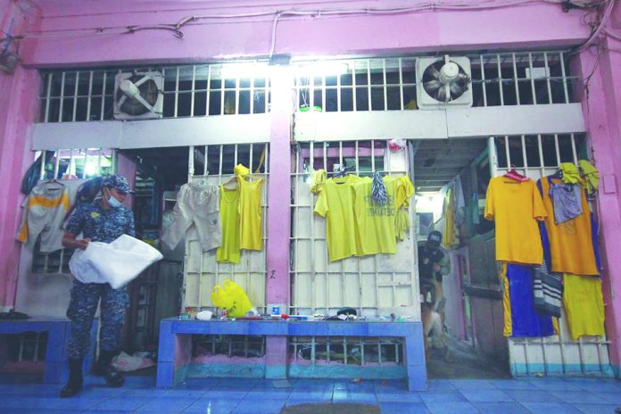 A Bureau of Jail Management and Penology personnel checks inmates’ cubicles inside the Quezon City Jail A Bureau of Jail Management and Penology personnel checks inmates’ cubicles inside the Quezon City Jail. Nine inmates and nine personnel of the detention facility have since been isolated after they contracted coronavirus disease 2019. ABS-CBN NEWS