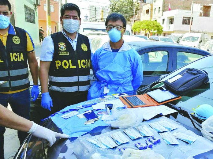 A Peruvian police photo showing Chinese citizen Zhang Tianxing (R) after his arrest for the unauthorized use of stolen COVID-19 tests in a street in Lima, on April 12. A Peruvian police photo showing Chinese citizen Zhang Tianxing (R) after his arrest for the unauthorized use of stolen COVID-19 tests in a street in Lima, on April 12. AFP