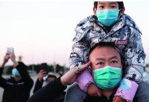 China sees rise in asymptomatic coronavirus cases A man wearing a face mask salutes during a ceremony where the Chinese national flag is positioned at half-mast, at Tiananmen Square in Beijing as China holds a national mourning for those who died of the coronavirus disease, on the Qingming tomb-sweeping festival, April 4, 2020. CHINA DAILY VIA REUTERS