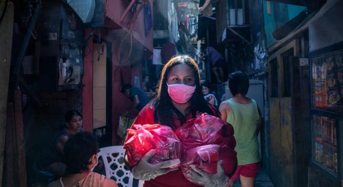 A woman is carrying food packs to be distributed among households A woman is carrying food packs to be distributed among households. On Wednesday, Finance secretary Carlos Dominguez III said half of the P200 billion to be distributed to people whose livelihoods were affected by the enhanced community quarantine imposed to curb the coronavirus pandemic is now available. GETTY IMAGES