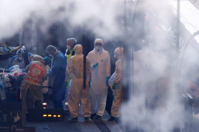 COVID-19 Medical personnel Medical personnel transfer a patient to a TGV high speed train, to continue with the evacuation of people infected with coronavirus disease to western France hospitals, at the Strasbourg railway station, in Strasbourg, France April 3, 2020. REUTERS