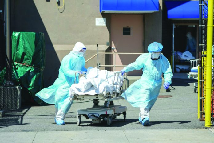 Bodies are moved to a refrigeration truck serving as a temporary morgue in New York, the main focus of the US outbreak, with more than 4,750 deaths. AFP