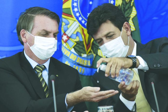 Brazil's Health Minister Luiz Henrique Mandetta Brazil's Health Minister Luiz Henrique Mandetta, right, gives anti-bacterial gel to President Jair Bolsonaro as they give a press conference on the new coronavirus at Planalto presidential palace in Brasilia, Brazil. AFP