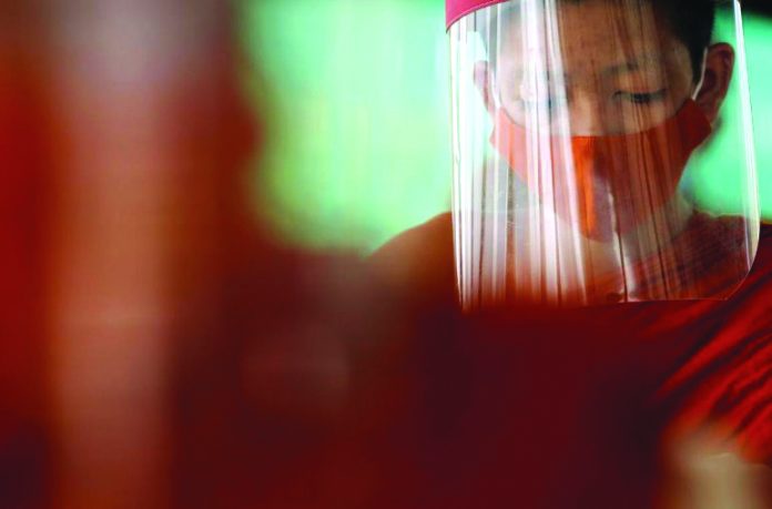 Buddhist novice monks wearing face shields and protective face masks Buddhist novice monks wearing face shields and protective face masks attend a lesson at Wat Molilokayaram monastic educational institute during coronavirus disease outbreak in Bangkok, Thailand on April 22, 2020. REUTERS