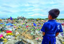 Struggle to Breathe: A story encapsulating the persistence of life through stifling hardships This young boy gazes at the sea of trash in Calajunan Sanitary Landfill, Mandurriao, Iloilo City. This dumpsite became his playground, where he forages for anything of value. Everyday, garbage trucks deliver tons of waste here. IAN PAUL CORDERO/PN