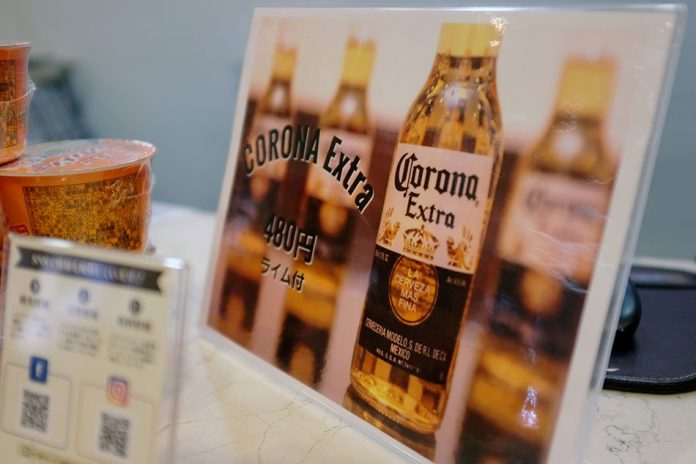 Corona beer A sign advertising discounted Corona beers is displayed at the front desk of the Osaka Corona Hotel in Osaka, Japan March 19, 2020. Picture taken March 19, 2020. REUTERS