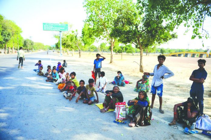 Homeless people wait along a road in Allahabad to receive free food during the nationwide lockdown Homeless people wait along a road in Allahabad to receive free food during the nationwide lockdown. AFP