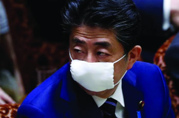 Japan's Prime Minister Shinzo Abe Japan's Prime Minister Shinzo Abe wears a protective face mask as he attends an upper house parliamentary session, following an outbreak of the coronavirus disease (COVID-19), in Tokyo, Japan April 1, 2020. REUTERS