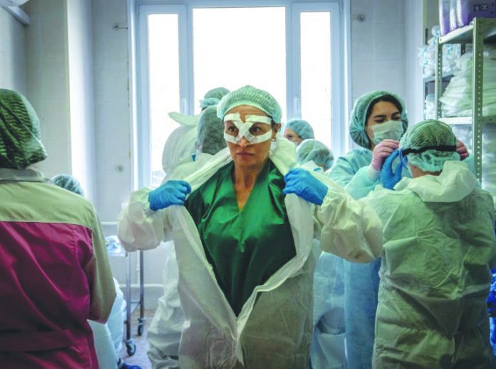 Medical workers Medical workers get ready for a shift treating coronavirus patients at the Spasokukotsky clinical hospital in Moscow, Russia. AFP