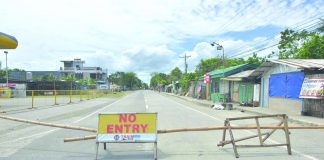 A makeshift barricade with no entry sign blocks the entrance to Barangay Tabucan, Barotac Nuevo, Iloilo. The said village was placed under heightened community quarantine after authorities recorded the first coronavirus disease 2019 case of the town. IAN PAUL CORDERO/PN
