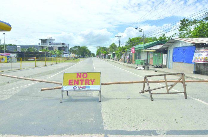 NO ENTRY A makeshift barricade with no entry sign blocks the entrance to Barangay Tabucan, Barotac Nuevo, Iloilo. The said village was placed under heightened community quarantine after authorities recorded the first coronavirus disease 2019 case of the town. IAN PAUL CORDERO/PN