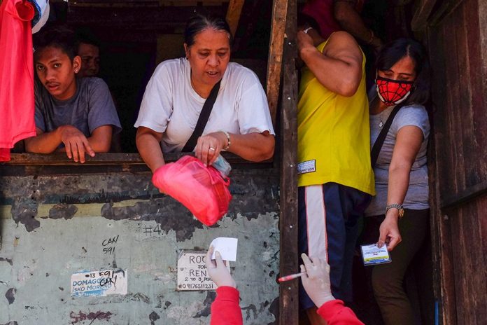 P100-B for first tranche of cash aid released Volunteers distribute goods in Barangay Batis, San Juan City on Mar. 23, 2020. ABS-CBN