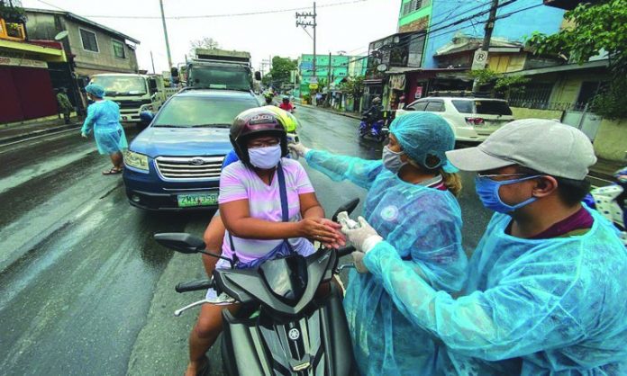 Quarantine personnel check body temperature of these motorists Quarantine personnel check body temperature of these motorists. According to the Philippine National Police, the number of quarantine and curfew violators of enhanced community quarantine guidelines has surpassed the 100,000 mark. ABS-CBN NEWS