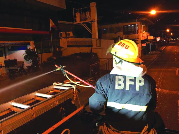 This fire officer disinfects the streets of Roxas City, Capiz on March 30 as one of the precautionary measures against the coronavirus disease 2019. Fire officers here have also been helping the police in conducting checkpoints to motorists and passengers. RCFS BFP