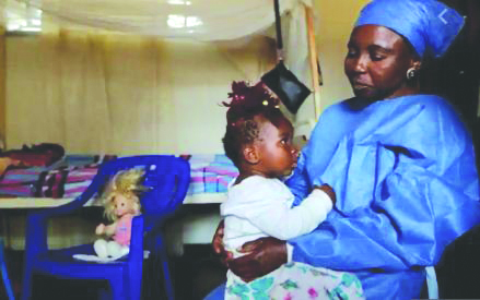 An Ebola survivor who works as a caregiver, takes care of a one-year-old An Ebola survivor who works as a caregiver, takes care of a one-year-old , an orphan whose mother died of Ebola in the Democratic Republic of Congo on Oct. 7, 2019. FILE PHOTO/REUTERS