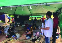 Antique extends ECQ until April 14 This healthcare worker from the Philippine Red Cross-Antique Chapter (right) conducts hygiene promotion to the Antiqueños that were stranded in Pandan, Antique due to the coronavirus disease 2019. The stranded persons cannot yet go home to their respective municipalities until the end of the enhanced community quarantine in the province. PHILIPPINE RED CROSS-ANTIQUE CHAPTER