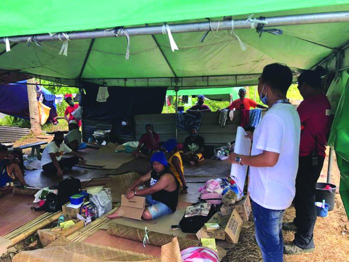This healthcare worker from the Philippine Red Cross-Antique Chapter (right) conducts hygiene promotion to the Antiqueños that were stranded in Pandan, Antique due to the coronavirus disease 2019. The stranded persons cannot yet go home to their respective municipalities until the end of the enhanced community quarantine in the province. PHILIPPINE RED CROSS-ANTIQUE CHAPTER