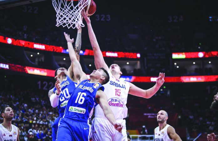 Two players of the Philippines men’s national basketball team battle for a rebound against a Serbian player during the 2019 FIBA World Cup in China. Due to the coronavirus disease outbreak, international basketball matches have been postponed. GET REAL POST