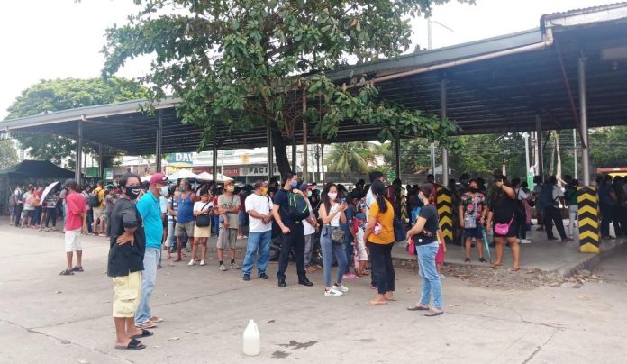 Commuters waiting in vain for jeepneys that are hard to come by at the transport terminal in Barangay Ungka, Jaro, Iloilo City