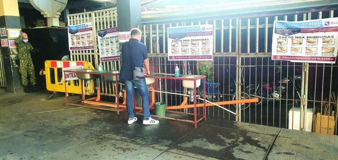 Handwashing station of the Kalibo Public Market This man cleans his hands at the handwashing station of the Kalibo Public Market. Kalibo vice mayor urged her residents to brace for new normal, saying the fight against coronavirus disease 2019 might still be far from over. JUN AGUIRRE