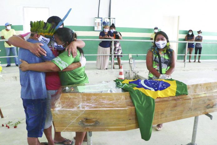 Mourners embrace during the funeral of Chief Messias Martins Moreira