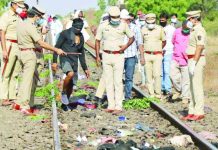 Indian train kills 14 workers laid-off in virus lockdown Police officers examine the railway track after a train ran over migrant workers sleeping on the track in Aurangabad district in the western state of Maharashtra, India, May 8, 2020. REUTERS